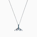 The Seaside 14K White Gold Blue Diamond Whales Tail Pendant (0.05 TCW) features a sparkling row of blue diamonds along the center, complemented by a thin chain and polished finish for an elegant, ocean-inspired look.