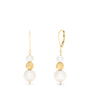 The 14K Yellow Gold Cultured Fresh Water Pearl Earrings feature yellow gold hooks, a textured gold bead, and two freshwater pearls—one small above and one larger below the bead—dangling from each earring.