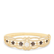The 14K Yellow Gold Diamond Filigree Bangle, 2.03 TCW, features intricate filigree patterns and sparkling diamond clusters, elegantly detailed along the band.