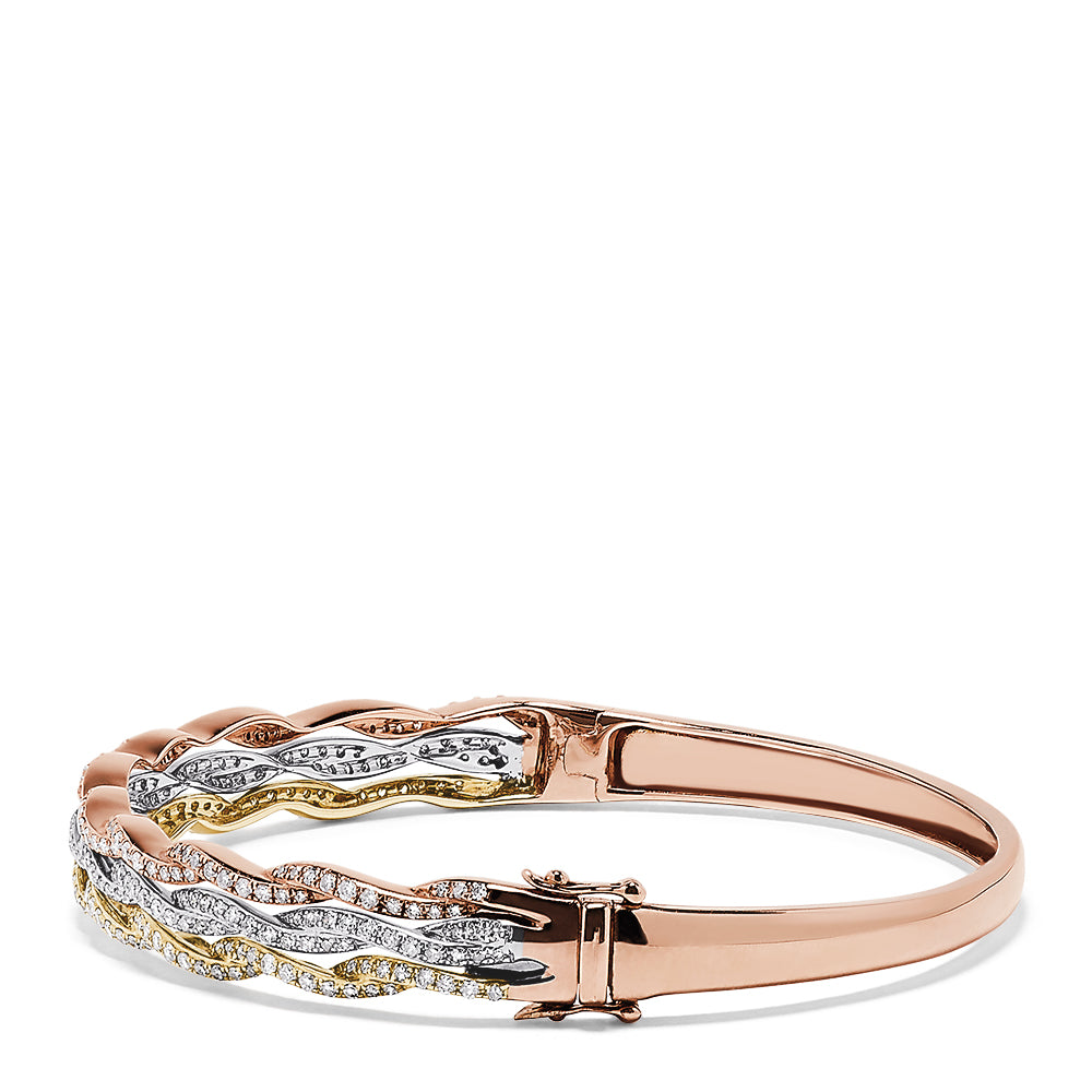 The Trio 14K Tri Color Gold Diamond Bangle, 1.42 TCW, showcases three wavy rows of white and yellow diamonds set in rose, white, and yellow gold for a brilliant, elegant look.