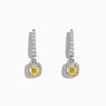 The Canare 18K Two-Tone Cushion Cut Yellow Diamond Drop Earrings (1.06 TCW) feature square yellow diamonds surrounded by clear stones, set in silver with extra clear stones along the drop. Displayed on a white background.