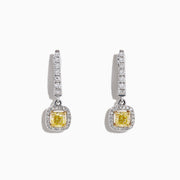 The Canare 18K Two-Tone Cushion Cut Yellow Diamond Drop Earrings (1.06 TCW) feature square yellow diamonds surrounded by clear stones, set in silver with extra clear stones along the drop. Displayed on a white background.