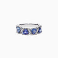 The Nahla Siri 14K White Gold Tanzanite Diamond Ring, 1.58 TCW, features three heart-shaped blue tanzanites set among wavy silver and diamond accents, shown on a white background.