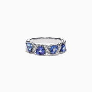 The Nahla Siri 14K White Gold Tanzanite Diamond Ring, 1.58 TCW, features three heart-shaped blue tanzanites set among wavy silver and diamond accents, shown on a white background.