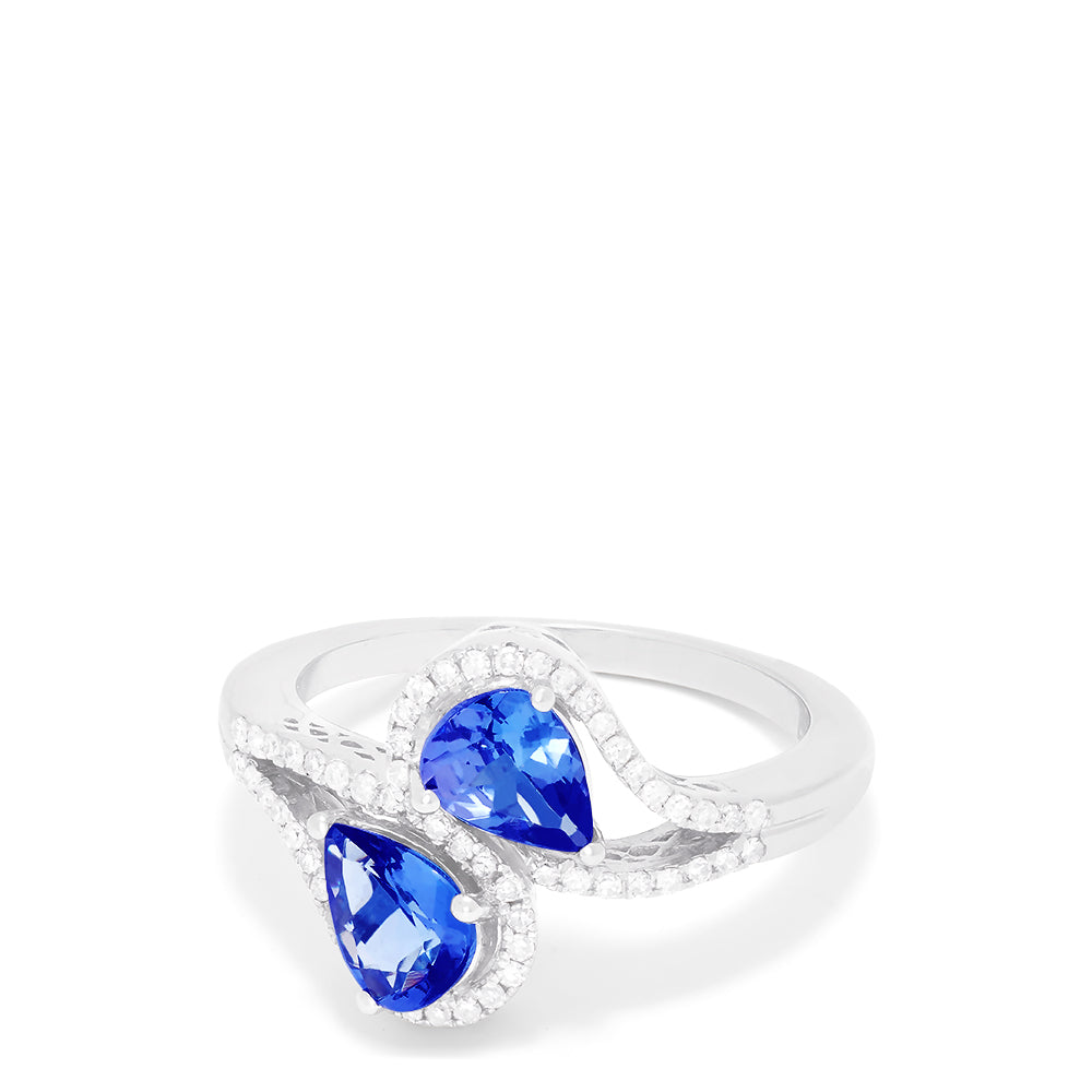 The 14K White Gold Pear Shaped Tanzanite and Diamond Bypass Ring, 0.74 TCW, features two pear-shaped blue tanzanites each with a diamond halo, set side by side in an elegant bypass design.