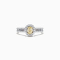 The Canare 18K Two-Tone Gold Yellow and White Diamond Ring, 0.71 TCW, features an oval yellow diamond center, haloed by white diamonds on a split band for a striking two-tone look.