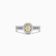 The Canare 18K Two-Tone Gold Yellow and White Diamond Ring, 0.71 TCW, features an oval yellow diamond center, haloed by white diamonds on a split band for a striking two-tone look.