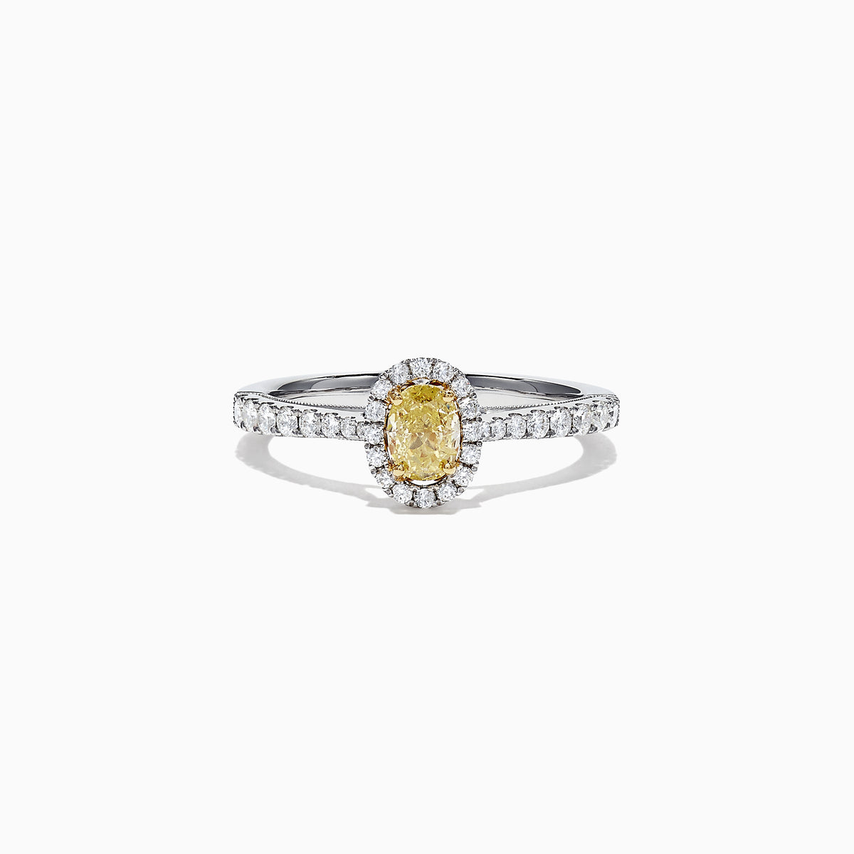 The Canare 18K Two-Tone Gold Yellow and White Diamond Ring, 0.79 TCW, showcases an oval yellow gemstone surrounded by a halo of clear diamonds and more diamonds on the band, beautifully displayed on a white background.
