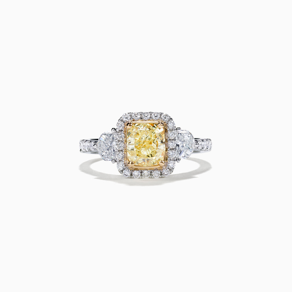 The Canare 18K Two-Tone Gold Cushion Cut Yellow Diamond Ring features a 2.19 TCW yellow center stone with a white diamond halo, two large side diamonds, and sparkling accents along the shank.