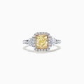 The Canare 18K Two-Tone Gold Cushion Cut Yellow Diamond Ring features a 2.19 TCW yellow center stone with a white diamond halo, two large side diamonds, and sparkling accents along the shank.