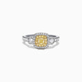 The Canare 18K Two-Tone Gold Cushion Double Halo Yellow Diamond Ring, 0.96 TCW, features a cushion-cut yellow diamond with a double white diamond halo and diamonds set along the band.