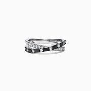 The 14K White Gold Black and White Diamond Crossover Ring, 0.77 TCW, features two intertwined bands with alternating black and white diamonds, displayed on a white background.
