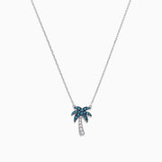 The Novelty 14K Gold Blue & White Diamond Palm Tree Necklace, 0.25 TCW, features sparkling gemstones on the leaves and trunk, beautifully displayed against a plain white background.