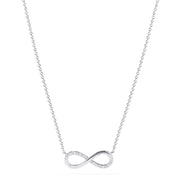 The Novelty 14K White Gold Diamond Infinity Necklace, 0.08 TCW, features a thin chain and an infinity symbol pendant partially adorned with sparkling diamonds, shown centered on a plain white background.