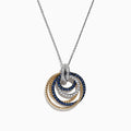 The Royale Bleu 14K 2-Tone Sapphire and Diamond Circles Pendant (1.09 TCW) features interlocking textured circles in gold and silver, encrusted with sapphires and diamonds, elegantly hanging from a delicate silver chain.