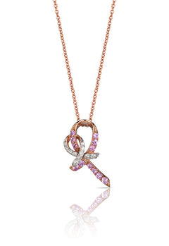 The 14K Rose Gold Pink Sapphire and Diamond Breast Cancer Awareness Ribbon Pendant (0.31 TCW) features a ribbon-shaped design adorned with pink sapphires and diamonds, symbolizing breast cancer awareness, on a white background.