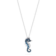 The Novelty 14K Gold Blue & White Diamond Seahorse Pendant, 0.62 TCW, features sparkling diamonds on its body and hangs elegantly from a delicate chain against a white background.