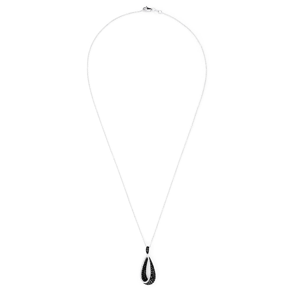 This 14K white gold pendant features a teardrop design accented with black diamonds on the inner curve and sparkling white diamonds on the outer edge, totaling 0.86 TCW for striking contrast.