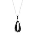 This 14K white gold pendant features a teardrop design accented with black diamonds on the inner curve and sparkling white diamonds on the outer edge, totaling 0.86 TCW for striking contrast.