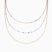 The 14K Tri Tone Gold Mirror Chain Necklace 17 features delicate oval and round links in rose gold, silver, and yellow gold tones, beautifully displayed against a white background.
