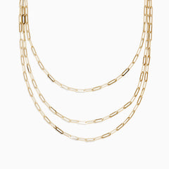The 14K Yellow Gold 18 Layered Paperclip Chain Necklace features three delicate chains with elongated rectangular links, elegantly displayed on a white background for a timeless, sophisticated look.