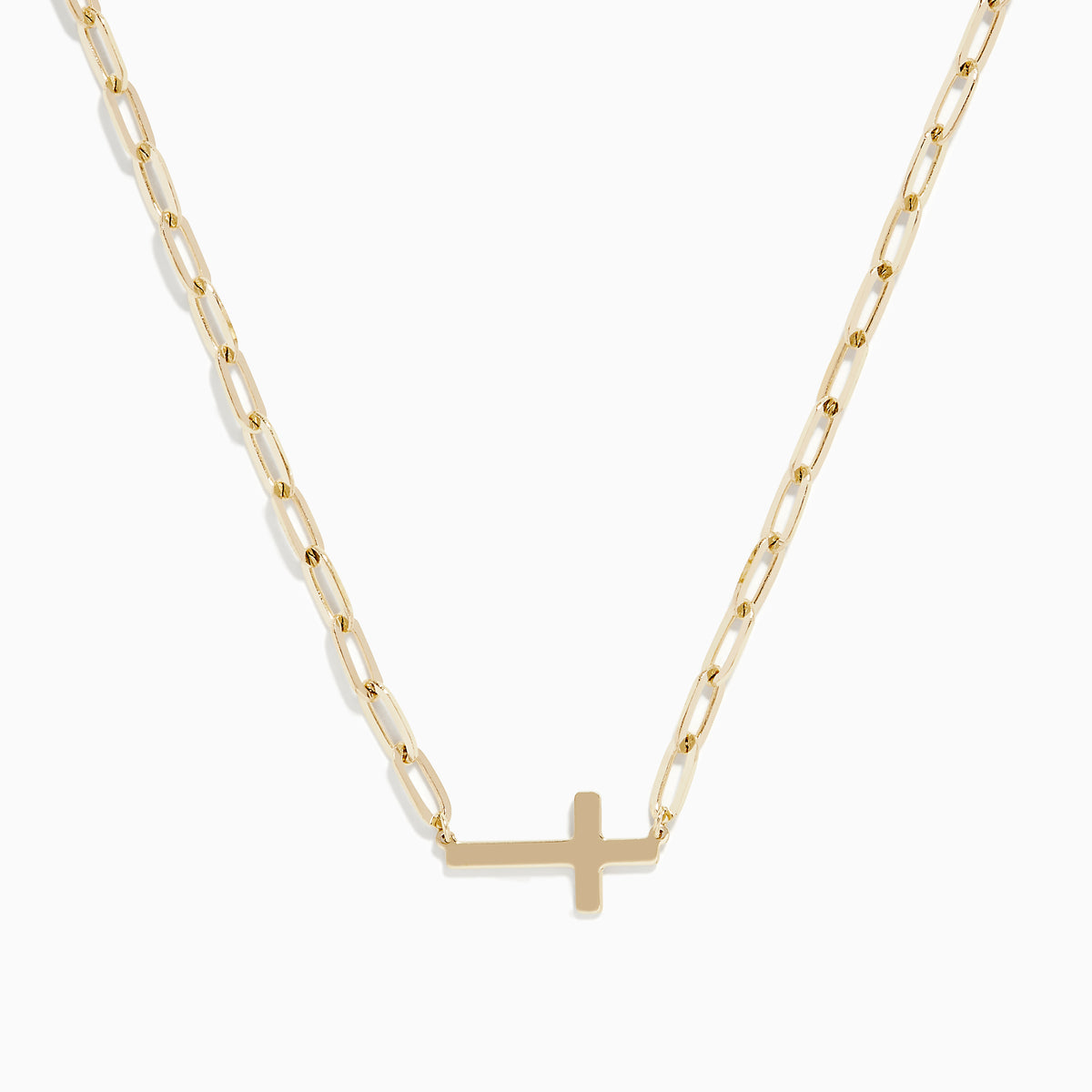 The 14K Yellow Gold West-East Cross Paperclip Chain Necklace 17 features a delicate paperclip chain and a small horizontal cross pendant, all crafted in 14K yellow gold.