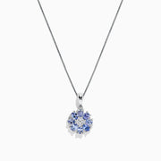 A 925 Sterling Silver pendant featuring a floral cluster of round and oval light blue tanzanite and sapphire gemstones, 1.52 TCW, set against a white background.