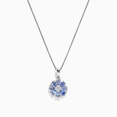 A 925 Sterling Silver pendant featuring a floral cluster of round and oval light blue tanzanite and sapphire gemstones, 1.52 TCW, set against a white background.