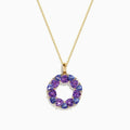 The 14K Yellow Gold Amethyst, Tanzanite, and Diamond Pendant features alternating colorful gemstones in a circular design, hanging elegantly from a delicate gold chain.