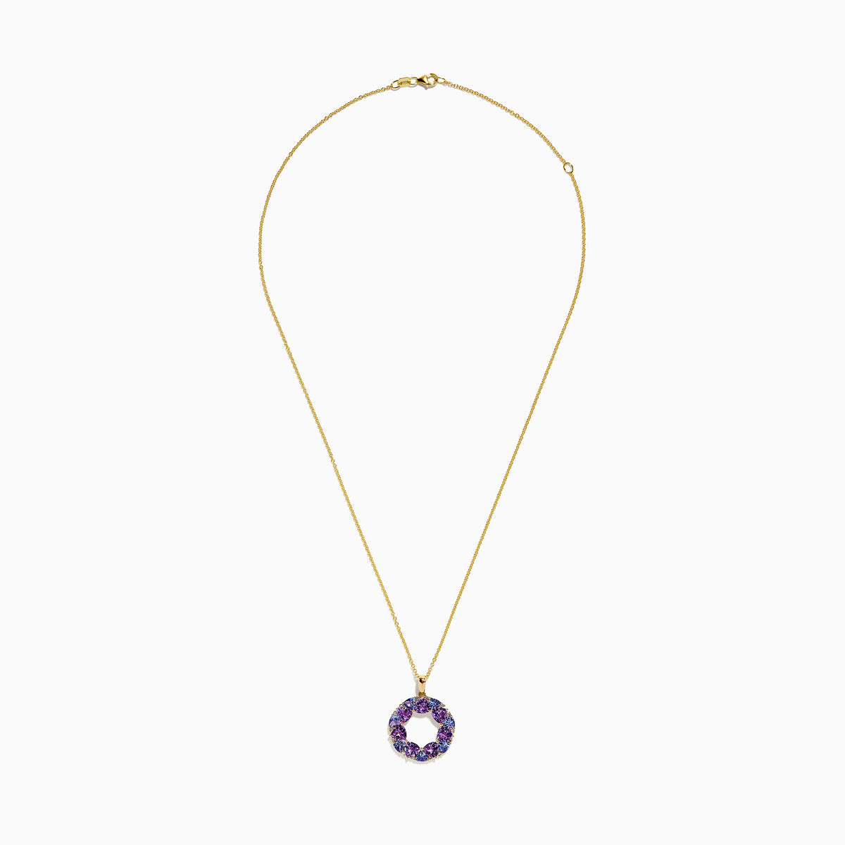 A 14K yellow gold necklace with a thin chain and a circular pendant featuring amethyst, tanzanite, and diamond gemstones, displayed on a white background.