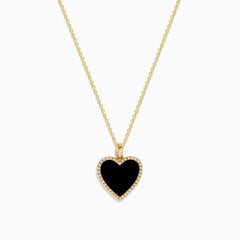 The 14K Yellow Gold Onyx and Diamond Heart Pendant features a heart-shaped onyx accented with sparkling diamonds, all set on a classic yellow gold chain for an elegant touch.