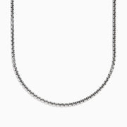 A close-up of the Mens Sterling Silver 21 Box Link Chain shows its sleek box chain design, displayed on a white background and curving gently at the bottom.