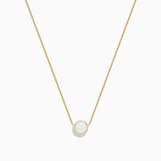 The Aurora 14K Yellow Gold Bezel Set Opal Necklace (0.55 TCW) features a round white opal pendant on a delicate gold chain—an elegant piece from the Effy Aurora collection.