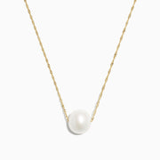 The 14K Yellow Gold Cultured Fresh Water Pearl Necklace features a single round freshwater pearl centered on a delicate gold chain, shown against a plain white background.
