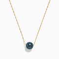 The 14K Yellow Gold Tahitian Pearl Necklace features a twisted gold chain and a single round black pearl centerpiece, elegantly displayed against a white background.