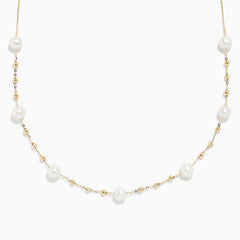 The 14K Yellow Gold 16 Pearl Station Necklace showcases evenly spaced white pearls and gold beads along a delicate chain.