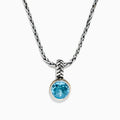 A 925 sterling silver necklace with an 18K gold-accented, round blue topaz pendant (7.36 TCW) is displayed on a white background.
