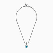 A 925 sterling silver necklace with an 18K gold-accented, round blue topaz pendant (7.36 TCW) is displayed on a white background.