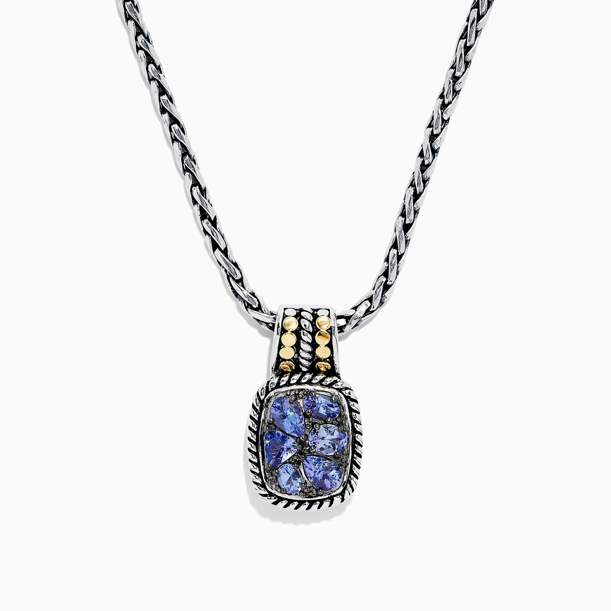 The Nahla Siri Silver & 18K Gold Tanzanite Pendant, 1.85 TCW, features a silver chain and a rectangular pendant with four blue tanzanites set in a decorative frame, accented by 18K gold at the top.