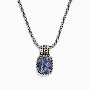 The Nahla Siri Silver & 18K Gold Tanzanite Pendant, 1.85 TCW, features a silver chain and a rectangular pendant with four blue tanzanites set in a decorative frame, accented by 18K gold at the top.