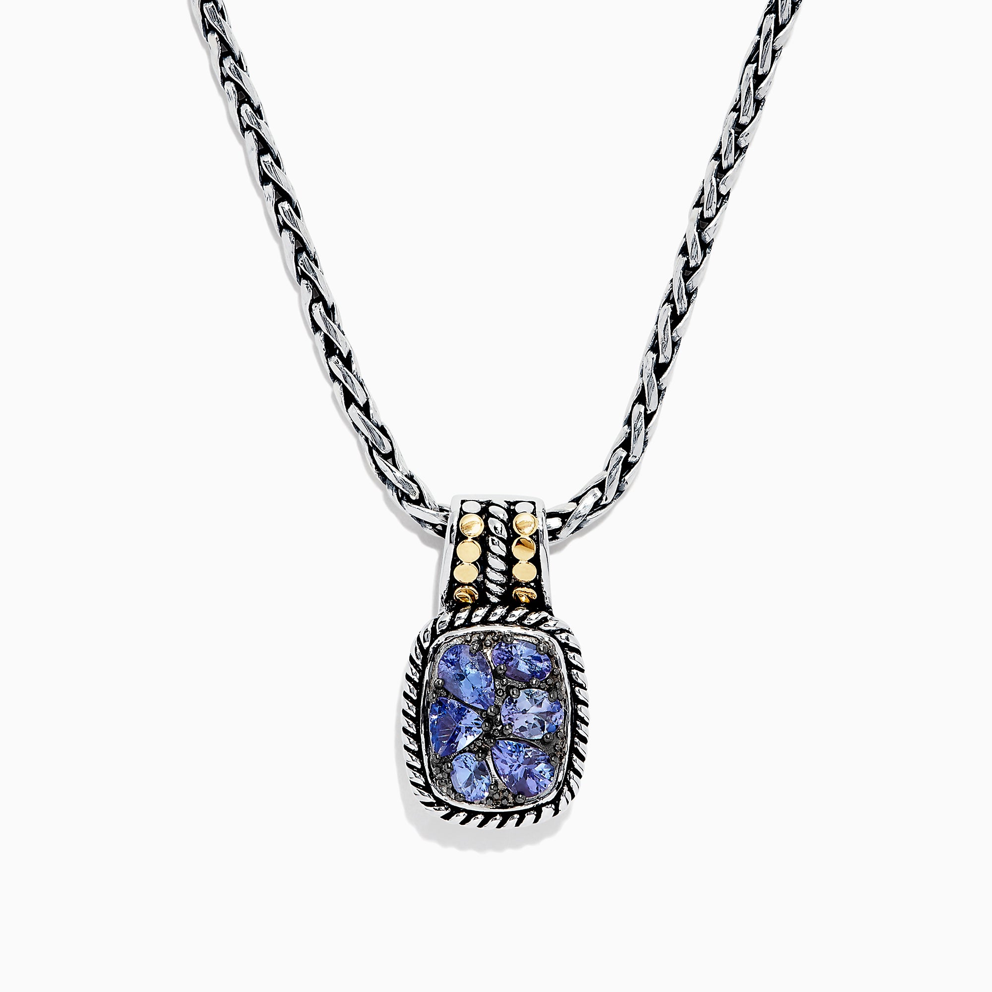 The Nahla Siri Silver & 18K Gold Tanzanite Pendant, 1.85 TCW, features a silver chain and a rectangular pendant with four blue tanzanites set in a decorative frame, accented by 18K gold at the top.