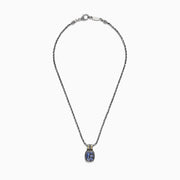 The Nahla Siri Silver & 18K Gold Tanzanite Pendant, 1.85 TCW, features a silver chain and a rectangular pendant with four blue tanzanites set in a decorative frame, accented by 18K gold at the top.