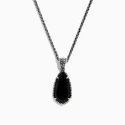 The Eclipse 925 Sterling Silver Onyx Pendant (4.56 TCW) showcases a large, teardrop-shaped onyx in a decorative bezel setting on a sterling silver chain, set against a white background.