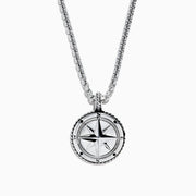 The Mens Sterling Silver Compass Pendant features a silver chain, a round pendant with a raised star, and engraved cardinal directions (N, E, S, W)—a bold accessory for any style.