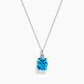 A 14K White Gold Blue Topaz and Diamond Pendant (6.93 TCW) with a square-cut blue topaz hangs from a silver chain, showcased against a white background.
