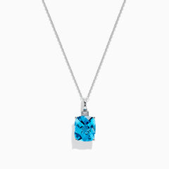 A 14K White Gold Blue Topaz and Diamond Pendant (6.93 TCW) with a square-cut blue topaz hangs from a silver chain, showcased against a white background.