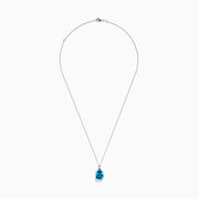 A 14K White Gold Blue Topaz and Diamond Pendant (6.93 TCW) with a square-cut blue topaz hangs from a silver chain, showcased against a white background.