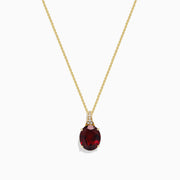 The Bordeaux 14K Yellow Gold Garnet and Diamond Pendant (4.68 TCW) features a fine chain and a striking oval deep red garnet accented by sparkling diamonds above the stone.