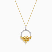 The 14K Yellow Gold Yellow and White Diamond Pendant (1.75 TCW) features a thin chain and a diamond-studded circular pendant with textured gold leaves forming a floral cluster for an elegant, intricate look.