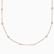 The 14K Rose Gold 18 Diamond Station Necklace features round bezel-set diamonds totaling 0.75 TCW, elegantly arranged and shown on a plain white background.